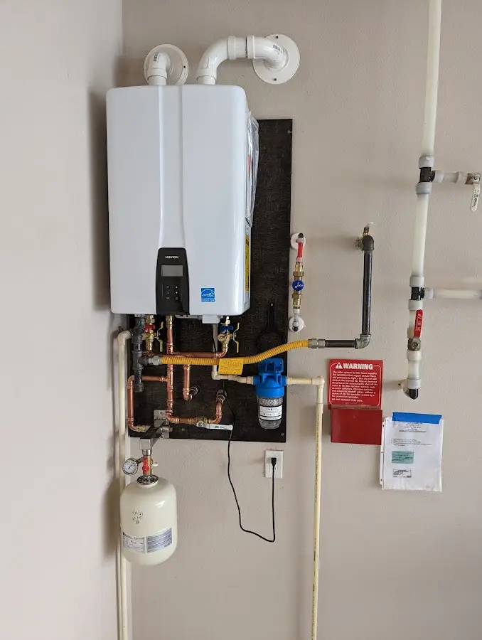 Professional plumber installing copper piping in a East Grand Rapids home