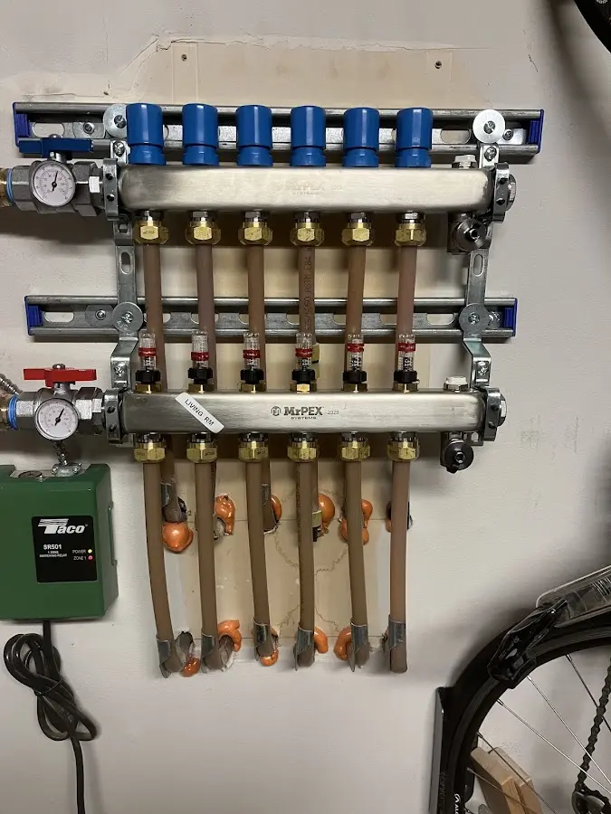 Plumber performing Water Heater Repair at a residential property in East Grand Rapids